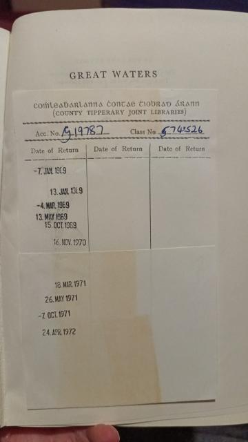 The checkout record insert of another library book with date stamps from 1969 to 1972, and the name of the library in Irish and English language