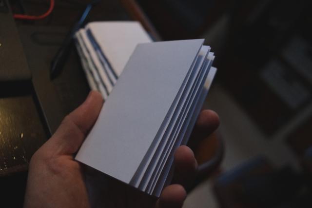 Four blank zines stitched together with a five hole binding stitch.