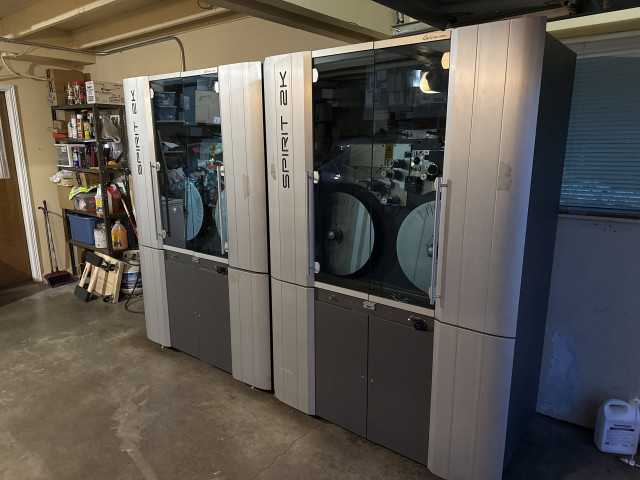 a big set of Spirit 2K film scanners. they look cool as fuck. they're beautiful brushed stainless steel on the sides and a big glass view door to watch the film transport mechanims

they're in a garage 