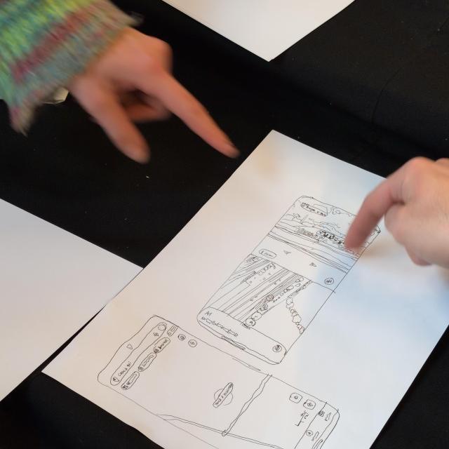 fineliner drawings tracing screenshots of a map on a phone, fingers pointing to it