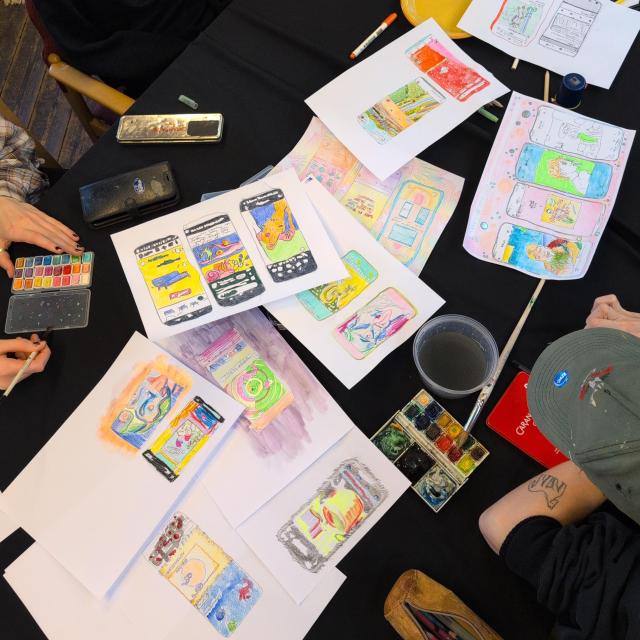 colorful drawings of different phone screens traced from screenshots, surrounded by watercolors and pencils