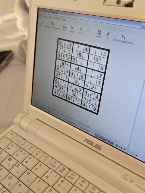 old small asus eee pc netbook running GNOME Sudoku, the game is halfway finished and the status bar at the bottom reads: "16 years, 10 months, 2 weeks, 6 days, 22 hours, 27 minutes an..."