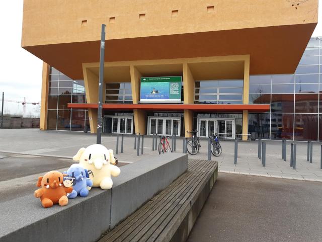 Das Veranstaltungsgebäude von außen, davor ein paar Plüschmastodons als "Aufbauhelfer".