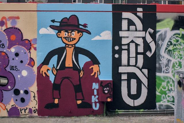 A painting of a cowboy with two bananas in his pockets.