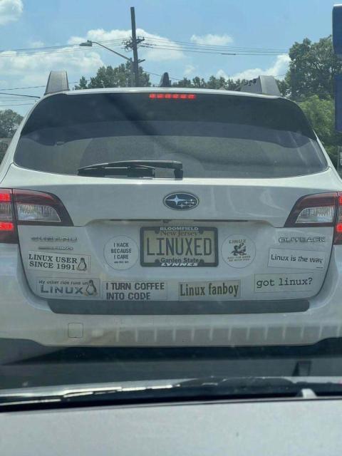 There is a Subaro Outback (car), whose rear end is filled with stickers that say: Linux user since 1991, My other ride runs on Linux, I hack because I care and free wifi, I turn coffee into code, Linux fanboy, Linux may the beer be with you, Linux is the way, and got Linux?

The car's number plate says: Bloomfield, New Jersey, LINUXED, Garden State, and LYNNES.
