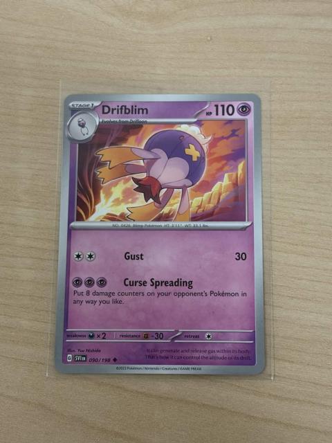A photo of a Pokémon card, depicting the ghost-type Drifblim. This Pokémon is significant because it shares its name with the Uxntal assembler. The card's description reads:

It can generate and release gas within its body. That's how it can control the altitude of its drift.