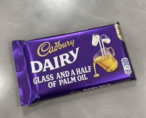 A fake bar of Cadbury "Dairy". The subtitle says "a glass and a half of palm oil" and the jug on the wrapper is pouring oil not milk.