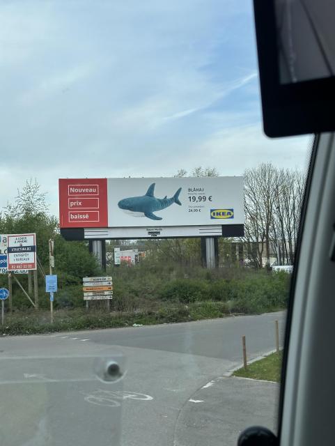 Giant ad of blahaj being on sale