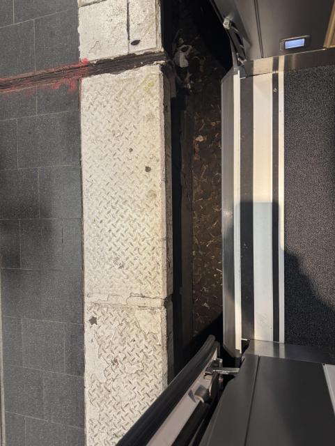 The entrance to a DB ICE L train. The is a gap between the train and the white edge paving of the platform.