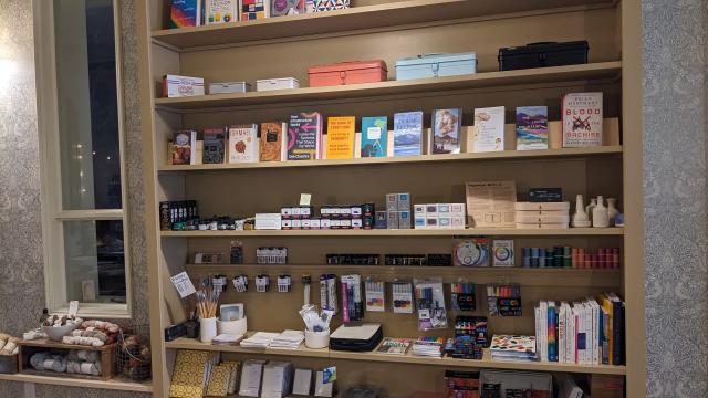 books and art supplies on a shelf at an art store