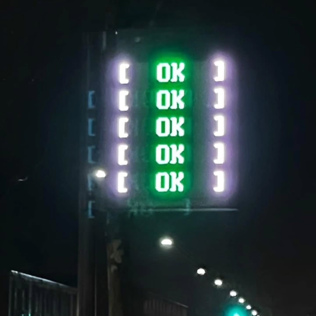There is a digital sign that says "[ok]" five times in green.