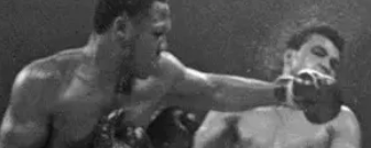 joes frazier knocking down muhammad ali with a left hook
