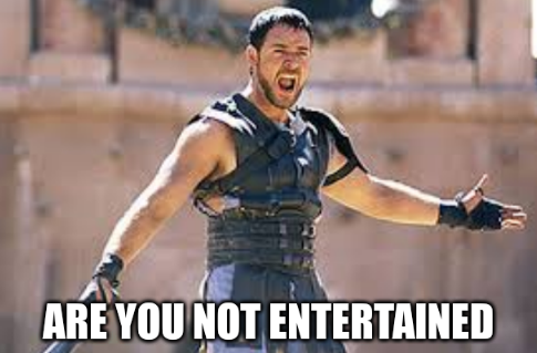 Still from the movie Gladiator, with russell crowe standing in the arena with his arms outstretched, shouting "Are you not entertained".