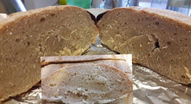 A piece of bread cut in half revealing that it's inner part is not cooked