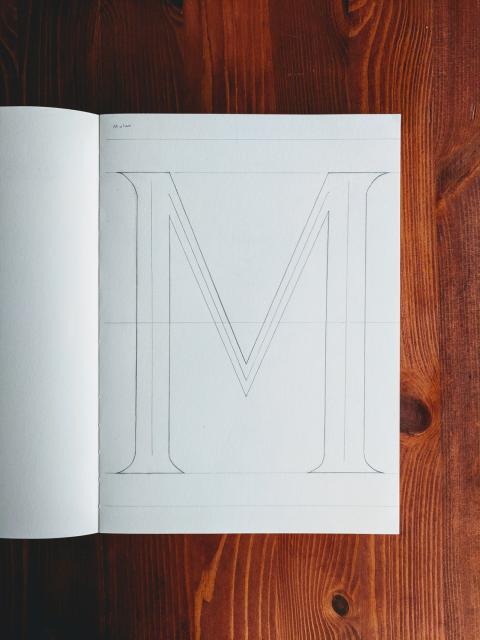 Sketch of a capital letter M in serif.