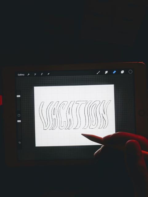 Work in progress photo of the same word "Vacation" but outlined.