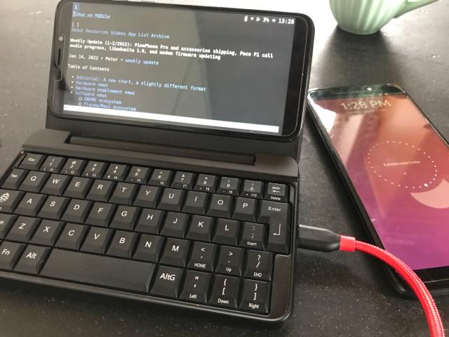 Two PinePhones, one running UBports and another one in the new PinePhone Keyboard running Sxmo.