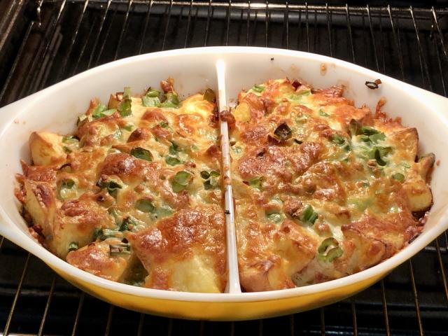 Baked cubes of potato topped with shallots, bacon and cheese