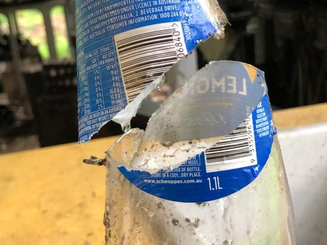 PET bottle cut in two. Both parts pictured to show the cut quality.