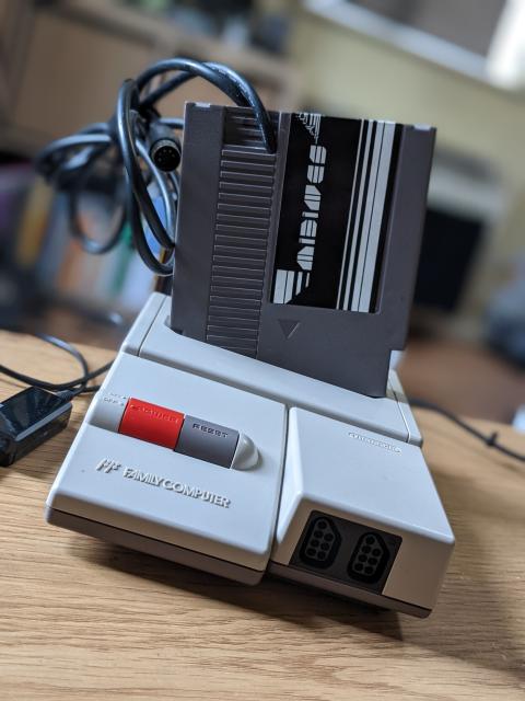 A MIDINES cartridge sitting awkwardly in a Japanese HVC-101. Without an adapter, it is not compatible.