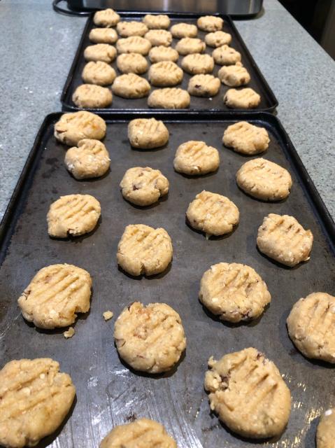 Two trays of biscuits before baking. 