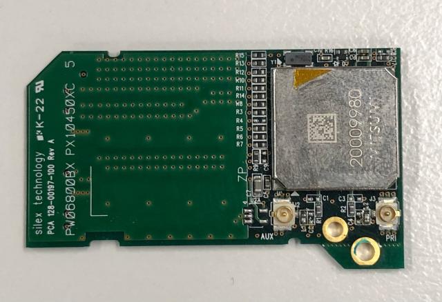 Back side if a small pcb in SD card form factor, showing a shielded chip and some wifi antenna terminals. 