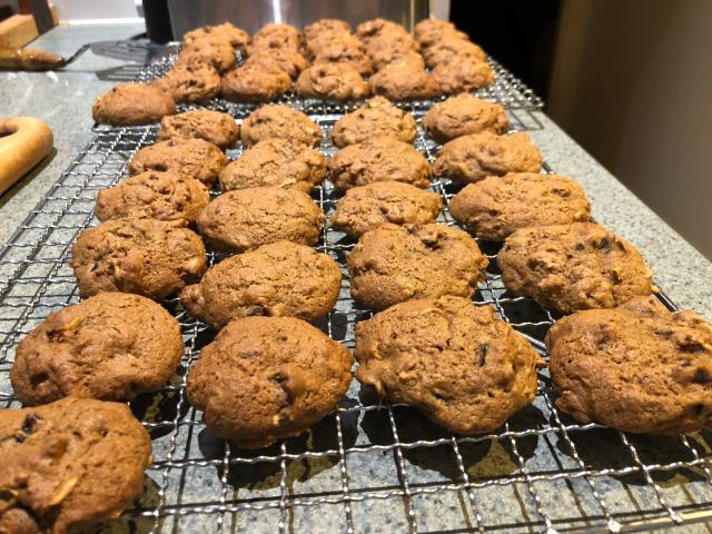42 roughly round domed biscuits on wire racks.  