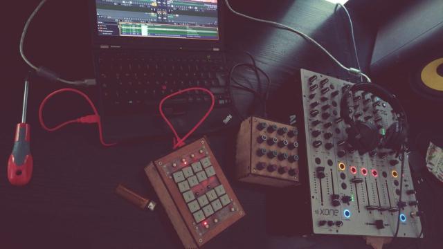Table with a xone96 mixer, a x230 thinkpad laptop, two diy midi controllers and a pair of sennheiser hd25 headphones. Oh and a screwdriver and a lighter for good measure.