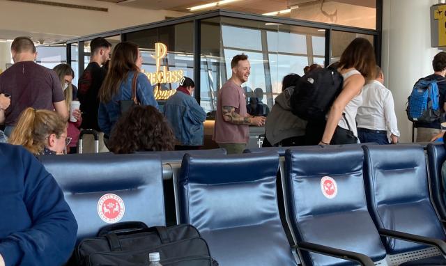 Unmasked people waiting to board 