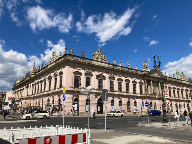 Enormous pale pink 18th century building against a blue sky