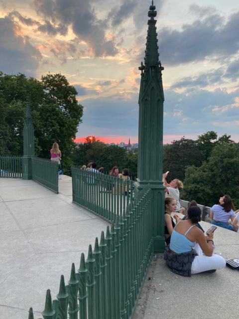 A line of red behind the monument and then a line of trees