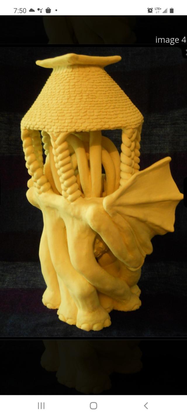 A surrealist ceramic sculpture with many vine-like elephant legs and dragon wings.