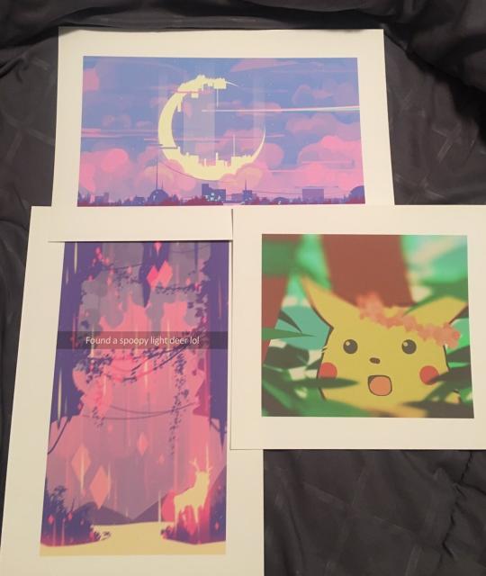 A photograph of 3 prints.
The first one at the top is the same as the previous pic.
The one at the bottom left is a digital art of the inside of a rainy cave, and there’s a deer to the left, and there’s a Snapchat text that says “Found a spoopy light deer lol”.
The one on the bottom right is a digital fanart of the surprised pikachu meme.