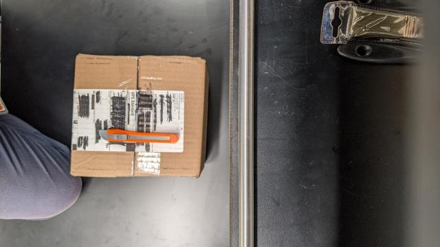 a small box with an exacto knife sitting on it and the label blacked out