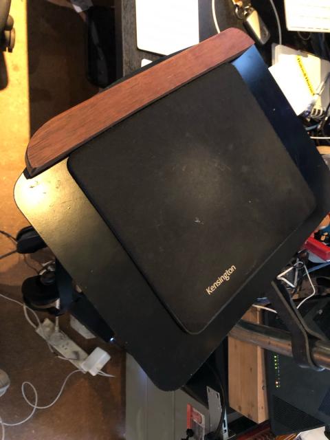 Top of tray has a mousemat for antislip and laptop base protection. And a wooden lip at the leading edge. 