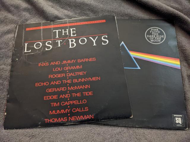 Two vinyl album covers, the soundtrack to The Lost Boys, and Dark Side of the Moon by Pink Floyd 