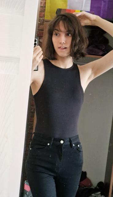 charlotte in black skinny jeans and a black stretchy bodysuit