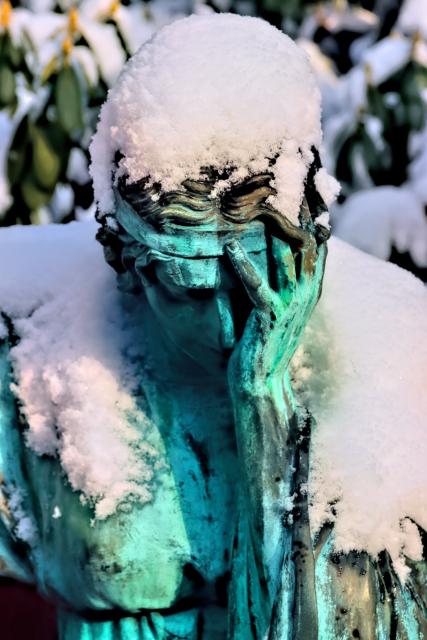 Image of snow-laden bronze sculpture in  Ohlsdorf Cemetery, Hamburg. Photo taken by Marek Studzinski, https://unsplash.com/photos/-IY166aB0V0.
