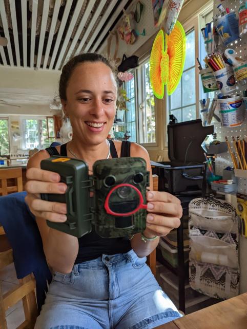 Denise testing out thr vision of the camera trap with a monocle.