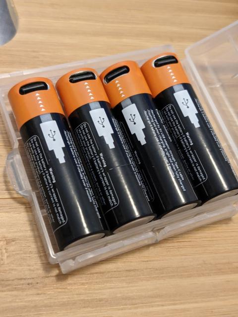 Four AA batteries with USB-C charging ports on them in a little plastic case. 