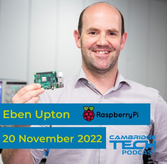 Eben Upton holding a Raspberry Pi next to his smiling face because he is very pleased with it