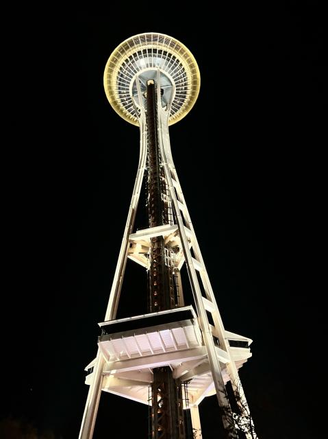 An up close shot of the Seattle space needle at night.