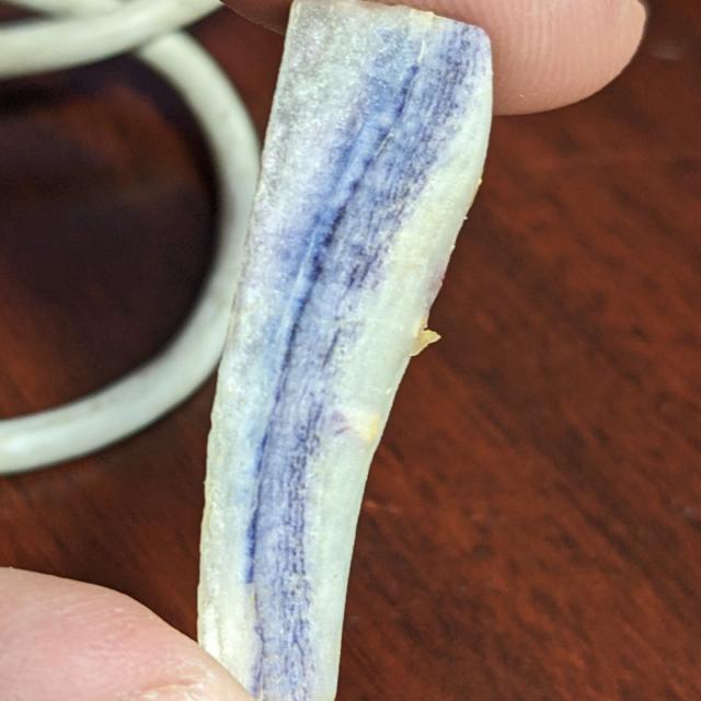 Carrot stick, white with blue and purple streaks throughout.