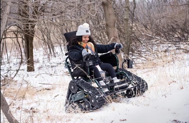 Brittanie Wilson traverses the snow in a track chair at Minnesota's Myre-Big Island State Park on March 22. (Deborah Rose/Minnesota Department of Natural Resources)