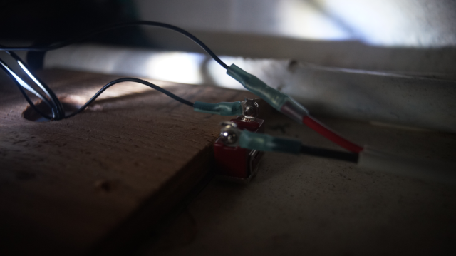 An electric switch seen from behind the wall.