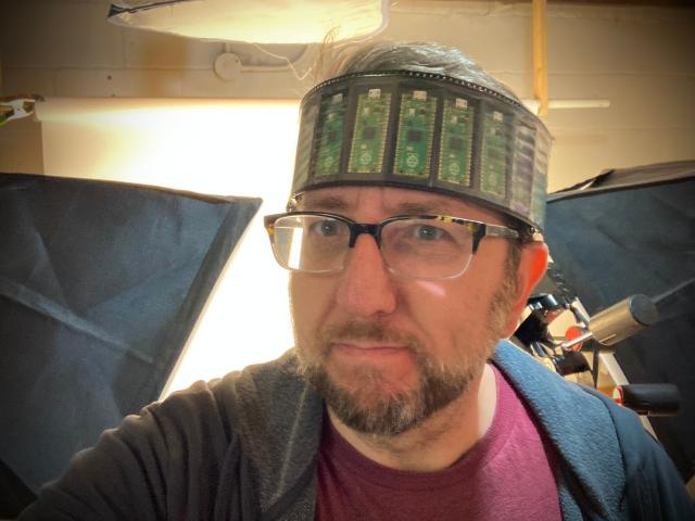 A foolish person wearing a crown made of Raspberry Pi Pico boards