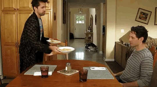 From the TV show It’s Always Sunny in Philadelphia. Mac despondently places a plate of food in front of Dennis. Dennis picks up the plate and sends it skimming down the hallway he is adjacent to. 