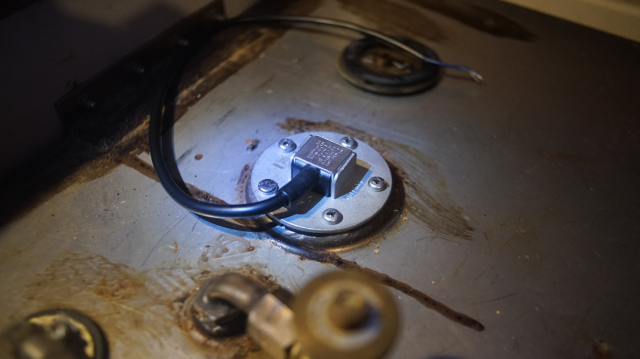 New fuel gauge cap on a stainless steel tank.