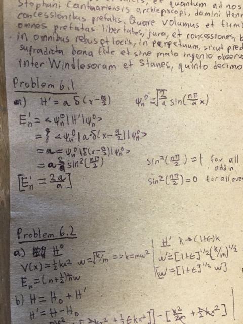 A close-up showing work for one of the problems. Latin text is visible above.