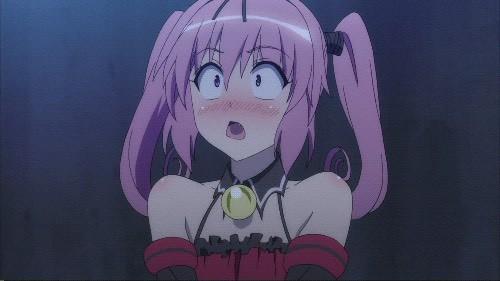 A blushing girl in twin ponytails goes from a shocked face to joyful enthusiasm.